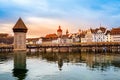 Old town of Lucerne, Switzerland at sunset in winter. Famous wooden Chapel Bridge on Reuss river and Lucerne lake. Swiss