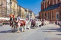 Old town market square of Krakow, Poland with horse carriages.