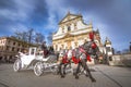 Old town market square of Krakow, Poland with horse carriages.