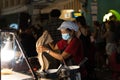 Thai street food cook woman wearing face mask.