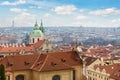 Old town Prague panoramic red rooftop view Saint Nicholas Church dome against Prague city skyline blue sky background