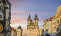 Old Town Prague and town square with the Astonomical Clock and the Our Lady Before Tyn church towers and spires under a colorful s Royalty Free Stock Photo
