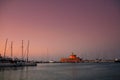 Old Town of Rhodos while pink sunset, calm sea, greek monument and harbour view. Warm colours, foggy background. Rhodos, Greece, E