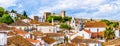 Old town skyline of Obidos, Portugal with house roof tops, church towers and the wall of the medieval castle located in the civil Royalty Free Stock Photo