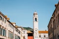 Old town Stradun street, Sponza Palace and clock tower in Dubrovnik, Croatia