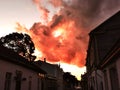 Old town street against dramatic red evening sky Royalty Free Stock Photo