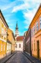 Old town street and buildings in the historical center of Budapest, Hungary. Lutheran Church of Budavar in the background. The Royalty Free Stock Photo