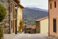 Old town street with colorful houses and with the mountain in the background in perspective. La Hiruela Madrid