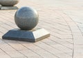 Old town street road brick background and granite ball. Royalty Free Stock Photo