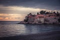 Old town Sveti Stefan on coastline during sunset in European country Montenegro