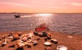 Nature sunset background Romantic beautiful sunset afternoon at sea on horizon Baltic Sea boat coral seashell on the rock sea sky Royalty Free Stock Photo
