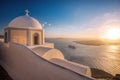 Old Town of Thira on the island Santorini, white church against colorful sunset in Greece