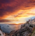 Old Town Thira on the Santorini island, famous churches against caldera with sunset over sea in Greece Royalty Free Stock Photo