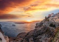 Old Town Thira on the Santorini island, famous churches against caldera with sunset over sea in Greece Royalty Free Stock Photo