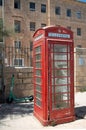 In the old town of Valletta on Malta there is an old weathered red telephone box. The symbol of the British crown can be seen at Royalty Free Stock Photo