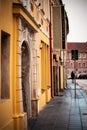 Old town Vilnius All Saints wet pavement street with yellow building