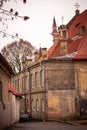 Old town Vilnius street with yellow brick wall building Royalty Free Stock Photo