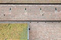 Old town-wall of bricks and two roofs with tiles Royalty Free Stock Photo