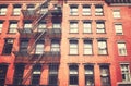 Old townhouse building with iron fire escape, color toning applied, New York City, USA Royalty Free Stock Photo