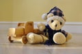 Old toy bear with a wooden car Royalty Free Stock Photo