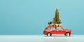 Old toy car with Christmas decorations and pine tree on the roof. Christmas is coming concept on light blue background with copy Royalty Free Stock Photo