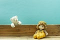 Old toy and Teddy bear on old wood in front blue background Royalty Free Stock Photo