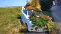 Old Trabant car parked planted many colorful flowers