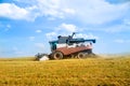 old tracktor plows the field. harvester harvests wheat from a sown agricultural field Royalty Free Stock Photo