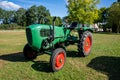 Old tractor in the Alpine meadows in the garden.