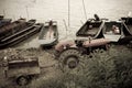 Old tractor and boats by river Royalty Free Stock Photo
