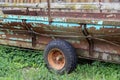 Old Tractor cart stands at a wooden barn