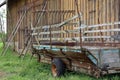 Old Tractor cart stands at a wooden barn Royalty Free Stock Photo