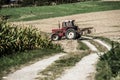 old tractor equipped with a plow in action in a field close-up Royalty Free Stock Photo