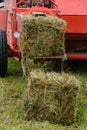 Old tractor in the field, forage harvesting for the winter, press and hay, pressing dry grass Royalty Free Stock Photo