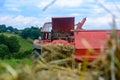 Old tractor in the field, forage harvesting for the winter, press and hay, pressing dry grass Royalty Free Stock Photo