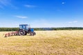 Old tractor in a field in the hay Royalty Free Stock Photo