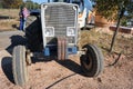 Front view of an old agricultural tractor with iron counterweights.