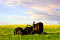 Old tractor left in a wyoming field on a summer blue sky day