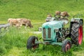 Old tractor on meadow. Beautiful mountain view in the Alps Royalty Free Stock Photo