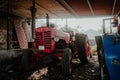 an old tractor is parked underneath a shed with its wheels