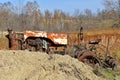 Old tractor partially hidden behind a pile of clay soil. Royalty Free Stock Photo