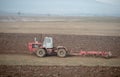 Old tractor during ploughing