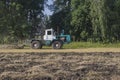 old tractor ploughs a field after harvesting of the grain Royalty Free Stock Photo