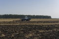 Old tractor ploughs a field after harvesting of the grain 6 Royalty Free Stock Photo
