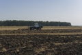 Old tractor ploughs a field after harvesting of the grain 6