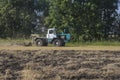 Old tractor ploughs a field after harvesting of the grain 4