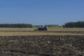 Old tractor ploughs a field after harvesting of the grain 3 Royalty Free Stock Photo