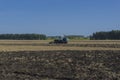 Old tractor ploughs a field after harvesting of the grain 3