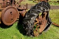 An old tractor with a rotten tire.