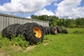 Old tractor tires stacked against old building